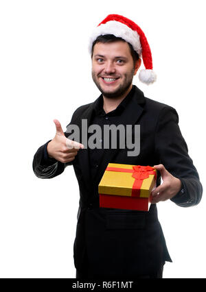 Image of brunet in Santa hat with gift in his hands Stock Photo