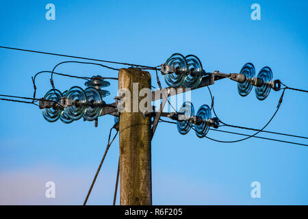 Electrical pole, with glass insulators. Stock Photo