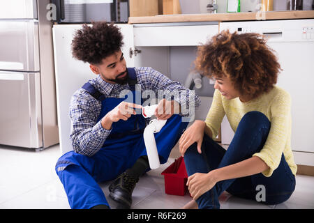 Plumber Looking At Damages Sink Pipe Stock Photo