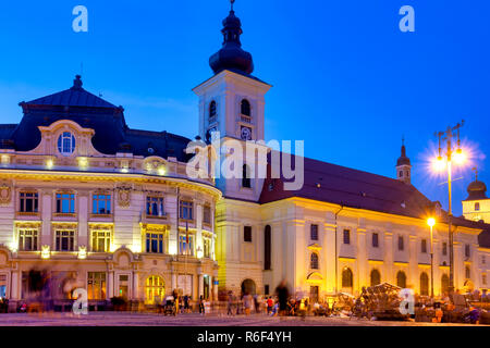 Sibiu city hall and the Holy Trinity Roman Catholic Church, Sibiu, Romania Stock Photo