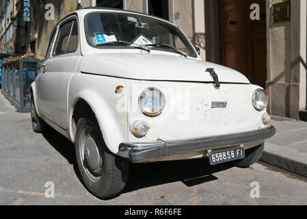 Horizontal close up of a dilapidated old Fiat 500 parked in Italy. Stock Photo