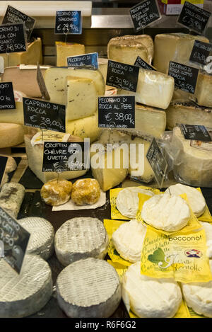 Vertical view of a chiller cabinet full of various Tuscan cheese. Stock Photo