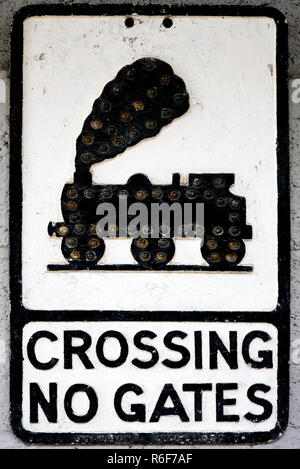 Vertical close up of an old black and white roadsign. Stock Photo