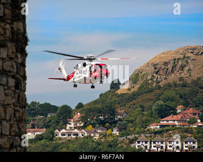 Horizontal view of a HM coastguards helicopter flying in the sky. Stock Photo