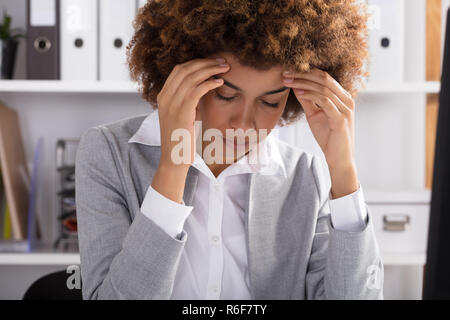 Portrait Of A Businesswoman Suffering From Headache Stock Photo