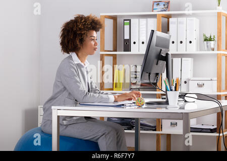 Young Businesswoman Working On Computer At Workplace Stock Photo