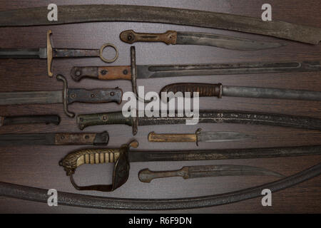 Historic swords and knives in a museum exhibit Stock Photo