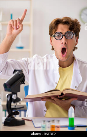 Funny crazy chemist doing experiments and tests Stock Photo
