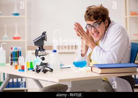 Funny crazy chemist doing experiments and tests Stock Photo