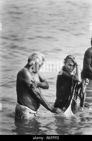 Couple bathing in Ganga river Ganges, India, old vintage 1900s picture Stock Photo