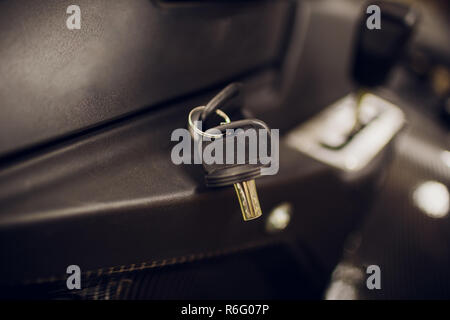 Ignition key modern car close up. Car atv key in keyhole Stock Photo