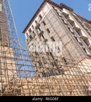 reinforcement for pouring concrete on the building background. marble finishing works on the facade of a high building Stock Photo