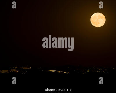 Big full moon shining over coastal resort of Cambrils Spain. Stock Photo