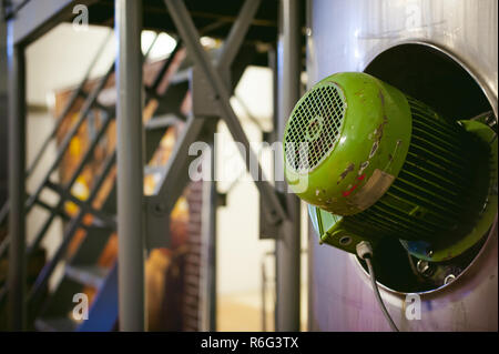 Beer manufacture line. Equipment for staged production bottling of Finished food products. Metal structures, pipes and tanks at enterprise factory. Special equipment inside within industrial premises Stock Photo