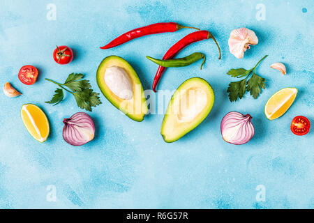 Ingredients for guacamole: avocado, lime, tomato, onion and spices, top view. Stock Photo