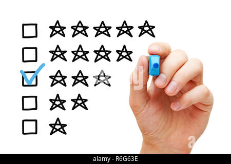 Hand putting check mark with blue marker on average three star rating. Stock Photo