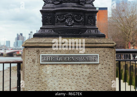 The Queen's Walk name sign. It is a promenade located on the southern bank of the River Thames in London, England, between Lambeth Bridge and Tower Br Stock Photo