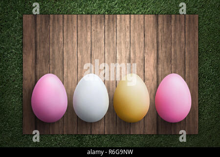 Row of Easter eggs on wooden plank Stock Photo
