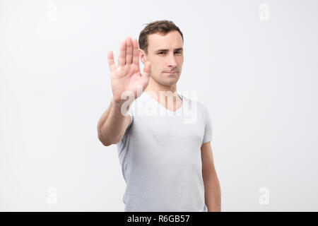 Young italian man shows stop timeout or refusal sign with hand Stock Photo