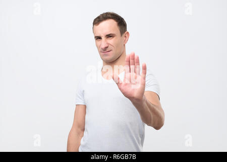 Young italian man shows stop timeout or refusal sign with hand Stock Photo
