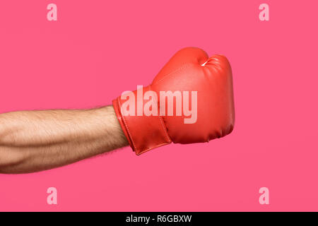 cropped shot of male hand in boxing glove isolated on pink Stock Photo