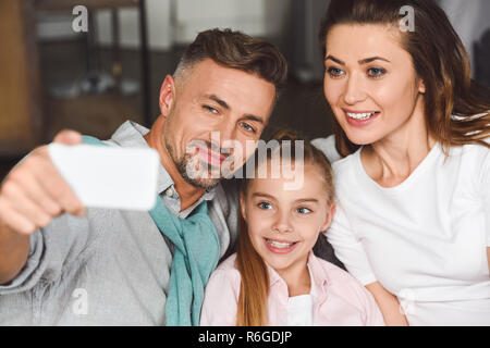 happy family taking selfie on smartphone at home Stock Photo