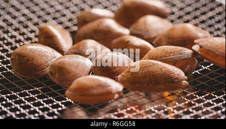 Grilled clams on barbecue fire Stock Photo