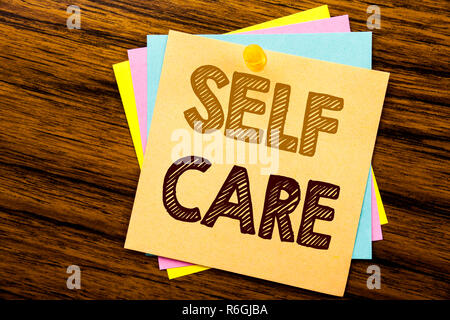 Conceptual hand writing text caption inspiration showing Self Care. Business concept for Taking caring for own Health written on sticky note paper on the wooden background. Stock Photo