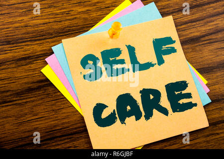Hand writing text caption inspiration showing Self Care. Business concept for Taking caring for own Health written on sticky note paper on the wooden background. Stock Photo