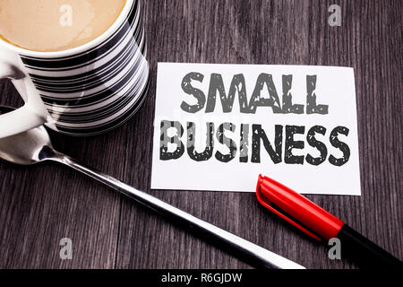 Conceptual hand writing text caption showing Small Business. Business concept for Family Owned Company written on sticky note paper on the wooden wood background. With coffee and marker Stock Photo