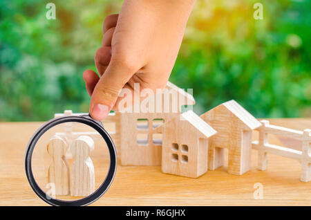 the family stands near their home. concept of real estate. buying, selling, renting a house. property insurance. affordable housing for young families Stock Photo