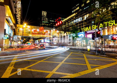 Tsim Sha Tsui, Hong Kong  - November 30, 2018 : Hong Kong Business District at Night with Light Track Stock Photo