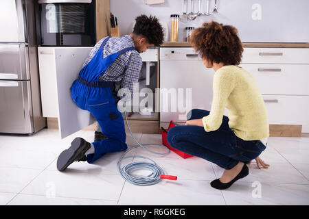 Male Plumber Cleaning Clogged Pipes Stock Photo