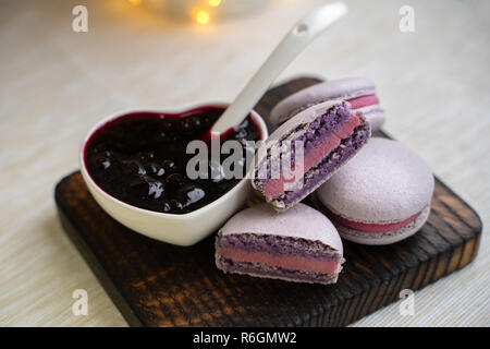 macaroons with currants on a white plate with jam Stock Photo