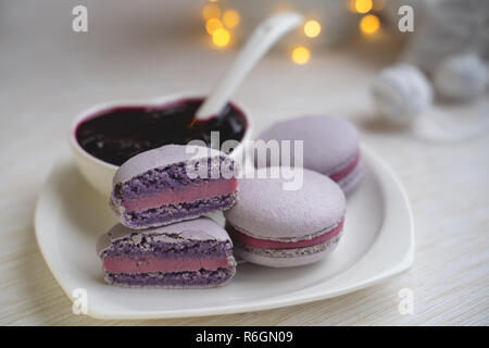 macaroons with currants on a white plate with jam Stock Photo