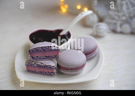 macaroons with currants on a white plate with jam Stock Photo