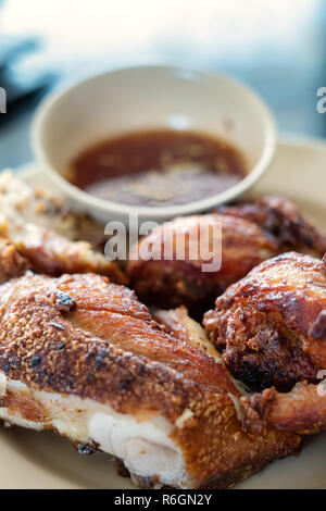 Fried chicken with spicy source in Thai menu style is served ready to be eaten. Stock Photo