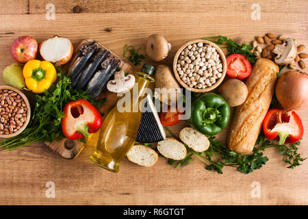 Healthy eating. Mediterranean diet. Fruit,vegetables, grain, nuts olive oil and fish on wooden table. Top view. Stock Photo