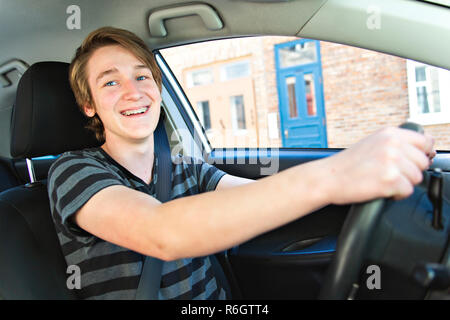 Teenage boy and new driver behind wheel of his car Stock Photo