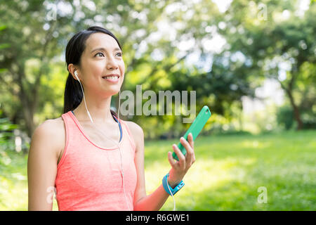 Sport woman listen to song on mobile phone Stock Photo
