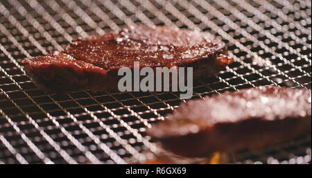 BBQ Steak on metal net Stock Photo