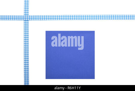 Checked ribbon and paper on white background Stock Photo
