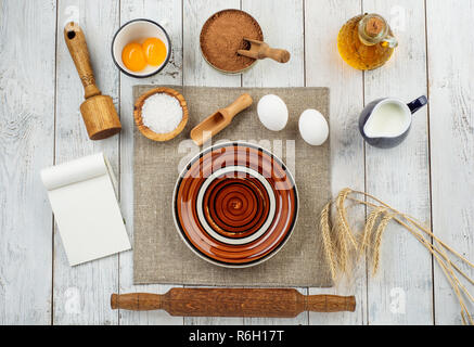 Dough preparation recipe bread, pizza or pie making ingridients, food flat lay on kitchen table background. Milk, yeast, flour, eggs, sugar pastry or bakery cooking. Stock Photo