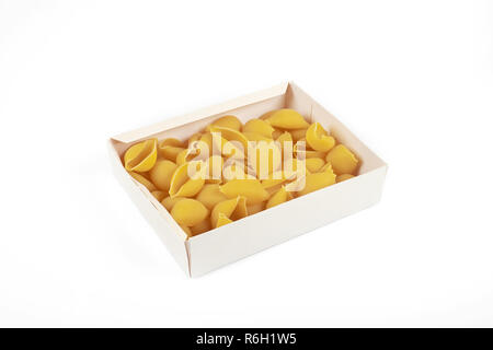 uncooked conchiglioni pasta shells in box , isolated on a white background. Stock Photo