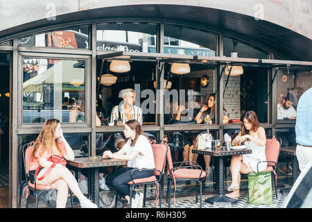 London/UK - July 20 2018: People sitting in a street cafe on Portobello Street, London, UK Stock Photo