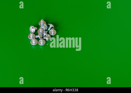 Nut screw many on the green background Stock Photo