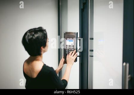 woman is calling on the intercom Stock Photo