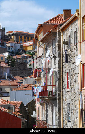 Colored facades and roofs of houses in Porto and the river Douro, Portugal. Porto is the second-largest city in Portugal after Lisbon Stock Photo