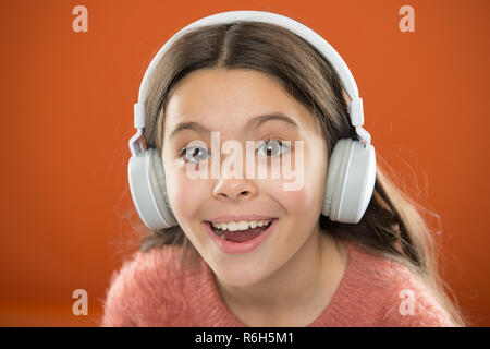 Girl child listen music modern headphones close up. Get music