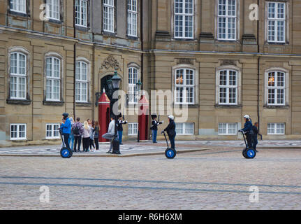 Segway riders passing Royal Life Guards on duty outside the Amalienborg Palace, Copenhagen, Denmark, Scandinavia Stock Photo